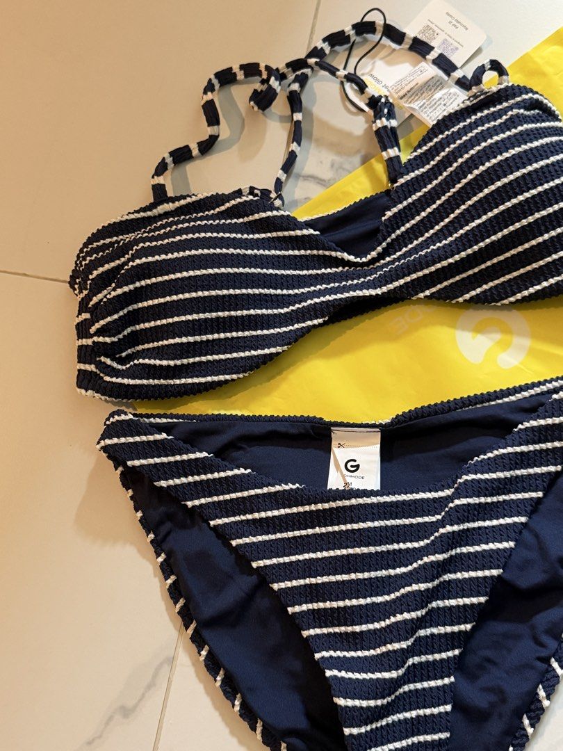 Glowmode Navy Blue Striped Textured Bikini Set (Category: Bikinis & Swimsuits) located in Mandaluyong City. Submitted by kayechx (Listing ID 1440268217, Image 2). Description: - Navy blue bikini set with white stripes - Super good quality, comparable to mall brands - Halter neck top with adjustable criss-cross back straps - Matching bikini bottoms included - Comes with a complimentary yellow pouch BRAND NEW NEVER WORN ONLY FIT RFS: too big, will 