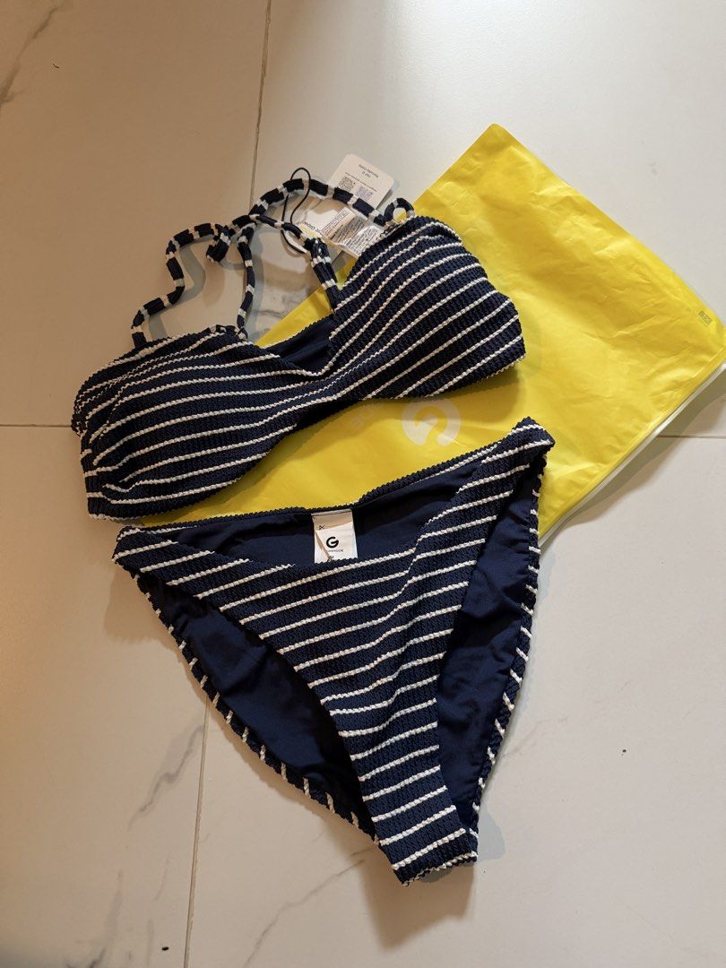 Glowmode Navy Blue Striped Textured Bikini Set (Category: Bikinis & Swimsuits) located in Mandaluyong City. Submitted by kayechx (Listing ID 1440268217, Image 1). Description: - Navy blue bikini set with white stripes - Super good quality, comparable to mall brands - Halter neck top with adjustable criss-cross back straps - Matching bikini bottoms included - Comes with a complimentary yellow pouch BRAND NEW NEVER WORN ONLY FIT RFS: too big, will 