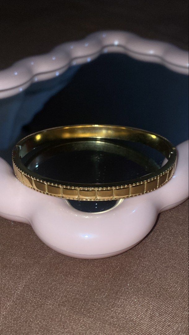 Gold Tone Bangle Bracelet with Square Detail (Category: Bracelets) located in Manila. Submitted by dianaclutz (Listing ID 1440240378, Image 1). Description: - Elegant gold-tone bangle bracelet - Features a repeating square pattern on the outer edge - Adds sophistication to any outfit - Perfect for everyday wear or special occasions -Non tarnish and hypoallergenic -Do not put in harsh chemical to avoid damage to it - A timeless addition to your je