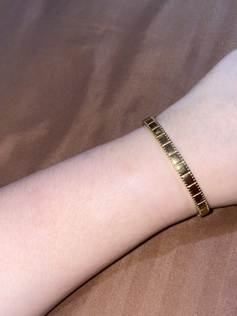 Gold Tone Bangle Bracelet with Square Detail (Category: Bracelets) located in Manila. Submitted by dianaclutz (Listing ID 1440240378, Image 3). Description: - Elegant gold-tone bangle bracelet - Features a repeating square pattern on the outer edge - Adds sophistication to any outfit - Perfect for everyday wear or special occasions -Non tarnish and hypoallergenic -Do not put in harsh chemical to avoid damage to it - A timeless addition to your je