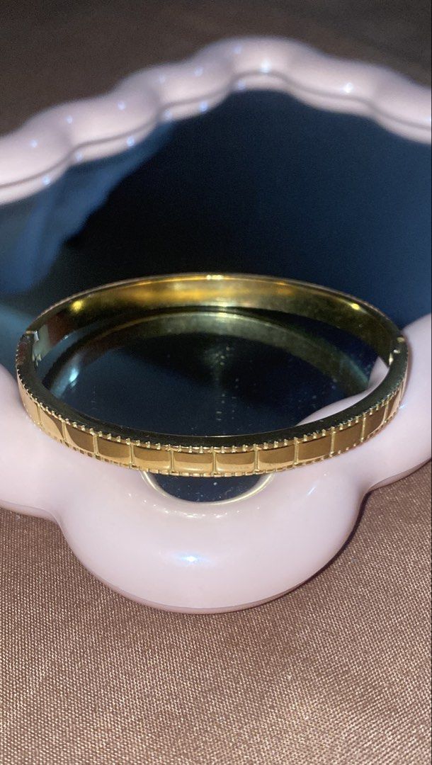 Gold Tone Bangle Bracelet with Square Detail (Category: Bracelets) located in Manila. Submitted by dianaclutz (Listing ID 1440240378, Image 2). Description: - Elegant gold-tone bangle bracelet - Features a repeating square pattern on the outer edge - Adds sophistication to any outfit - Perfect for everyday wear or special occasions -Non tarnish and hypoallergenic -Do not put in harsh chemical to avoid damage to it - A timeless addition to your je
