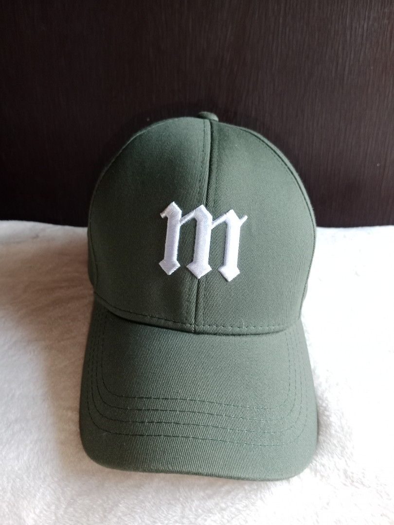 Green Baseball Cap with 'm' Logo (Category: Caps & Hats) located in Manila. Submitted by angeloarce64172 (Listing ID 1440232376, Image 1). Description: - Stylish green baseball cap - Prominent white 'm' logo on the front - Classic baseball cap design with curved brim - Adjustable brown leather strap at the back for a comfortable fit - Perfect for casual wear and adding sporty flair.