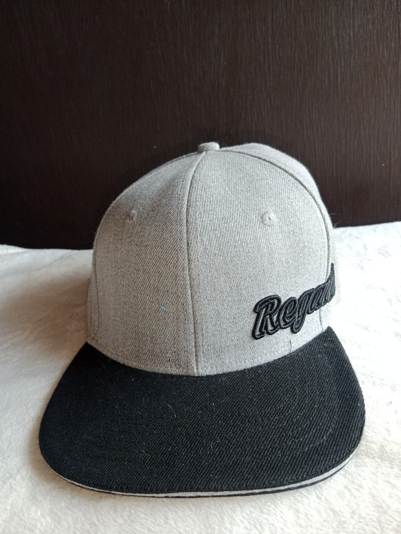 Grey and Black Snapback Cap with 'Regal' Embroidery (Category: Caps & Hats) located in Manila. Submitted by angeloarce64172 (Listing ID 1440250594, Image 1). Description: - Stylish snapback cap - Grey crown with black brim - 'Regal' embroidered in black on the side - Structured interior with adjustable snapback closure - Perfect for casual and urban style.