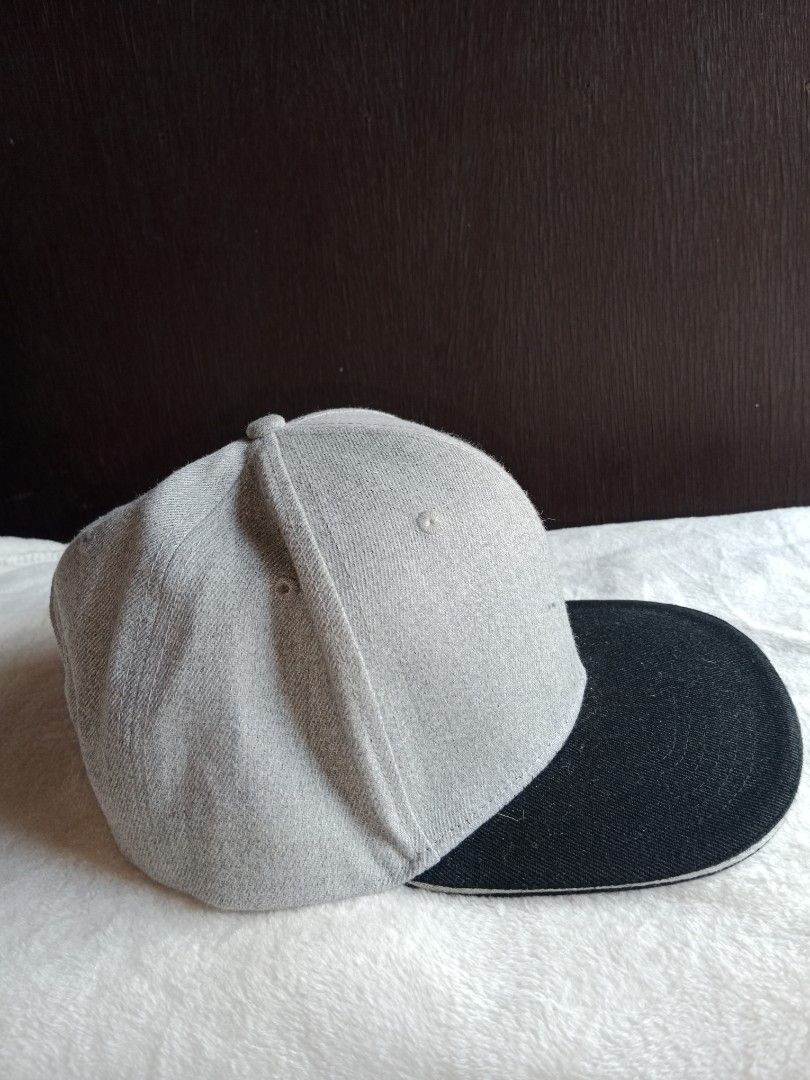 Grey and Black Snapback Cap with 'Regal' Embroidery (Category: Caps & Hats) located in Manila. Submitted by angeloarce64172 (Listing ID 1440250594, Image 2). Description: - Stylish snapback cap - Grey crown with black brim - 'Regal' embroidered in black on the side - Structured interior with adjustable snapback closure - Perfect for casual and urban style.