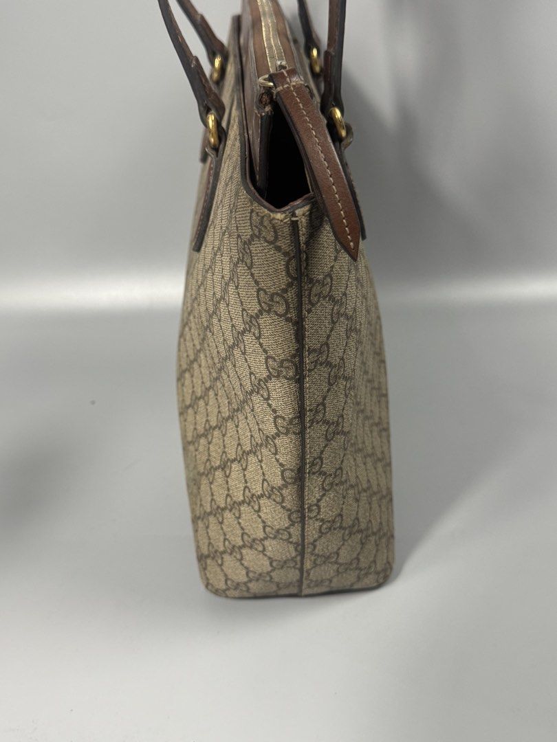 Gucci GG sprim tote bag (Category: Luxury Bags & Wallets) located in Quezon City. Submitted by streetgallerygarments (Listing ID 1440286555, Image 3). Description: Gucci GG Supreme canvas and leather tote bag featuring a top zip Materials: Coated Canvas, Cowhide Leather, and gold-tone metal hardware.Design Features: Flared trapeze silhouette, teardrop-shaped stitched leather handle mounts, a recessed upper zippered compartment, and a prominent br