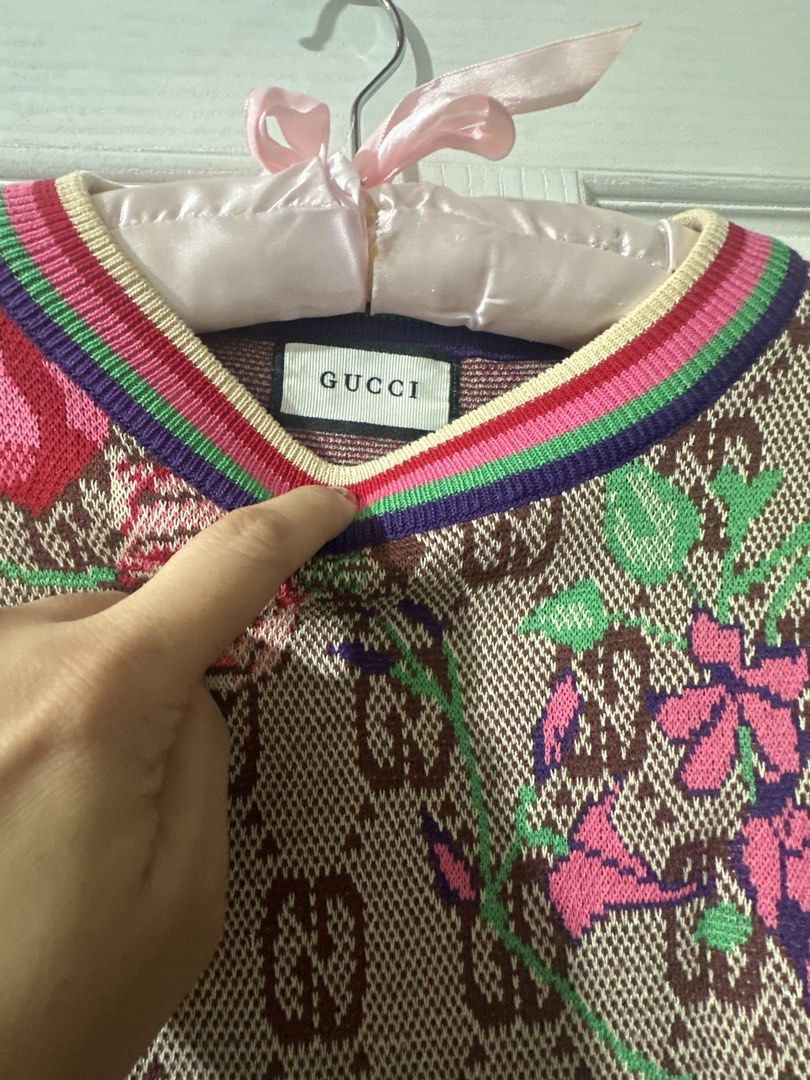 Gucci Monogram Floral Knit Sweater Top (Category: Blouses) located in Cabadbaran. Submitted by KsGoodFind (Listing ID 1440326911, Image 2). Description: - Gucci knit sweater - Ukay source - Features iconic GG monogram and floral print - Short sleeves with ribbed cuffs and hem - Colorful striped neckline detail - Perfect statement piece for any outfit -Fits M-L.