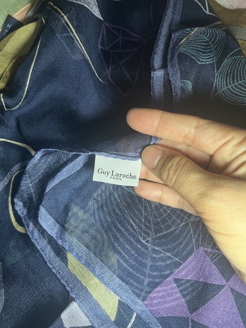 Guy Laroche Paris Scarf - Blue Geometric Leaf Print (Category: Scarves) located in Cebu City. Submitted by 7paws (Listing ID 1440377324, Image 1). Description: - Authentic Guy Laroche Paris scarf - Base color: Dark blue - Print: Geometric leaf and vine pattern - Colors: Purple, green, and yellow - Fabric: Lightweight with a beautiful drape - Versatile accessory to elevate any outfit.