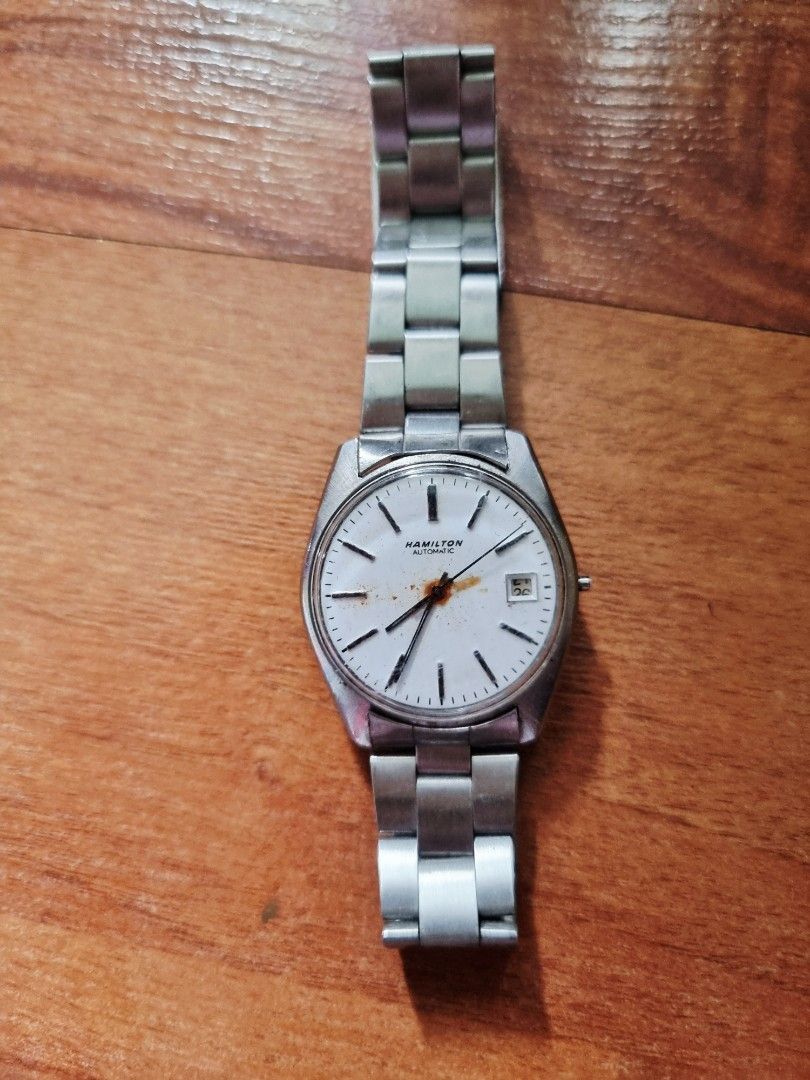 Hamilton Automatic Watch (Category: Luxury Watches) located in Quezon City. Submitted by apspc (Listing ID 1440274652, Image 1). Description: Vintage 1970 Hamilton Watch. Not working anymore and the strap has been replaced by Seiko metal strap. Has name engraving at the back. No box. Can meet up in malls - Trinoma, SM North or Robinsons Galleria.