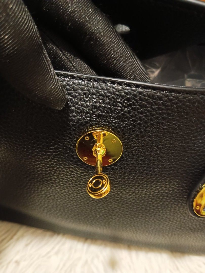 Hermes Black Leather Taurillon Clemence Lindy Bag (Category: Luxury Bags & Wallets) located in Digos. Submitted by chihanu (Listing ID 1440335913, Image 3). Description: - Genuine black Taurillon Clemence leather - Elegant gold hardware - Front flap closure with secure turn-lock - Versatile carrying options: two top handles and a detachable shoulder strap - Organized interior with multiple compartments - Pristine condition, clean inside and out -
