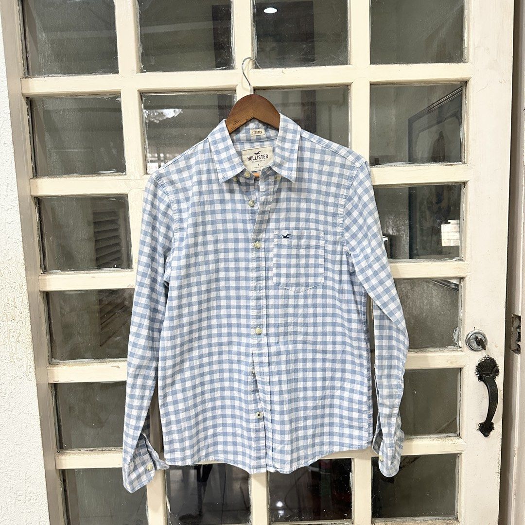 Hollister Blue Gingham Button Down Shirt Size S (Category: Tshirts & Polo Shirts ) located in Makati City. Submitted by _lovejoy (Listing ID 1440289473, Image 1). Description: - Classic blue and white gingham pattern - Long sleeves with button cuffs - Chest pocket with Hollister logo - Comfortable stretch fabric - Button-up front - Ideal for casual wear.