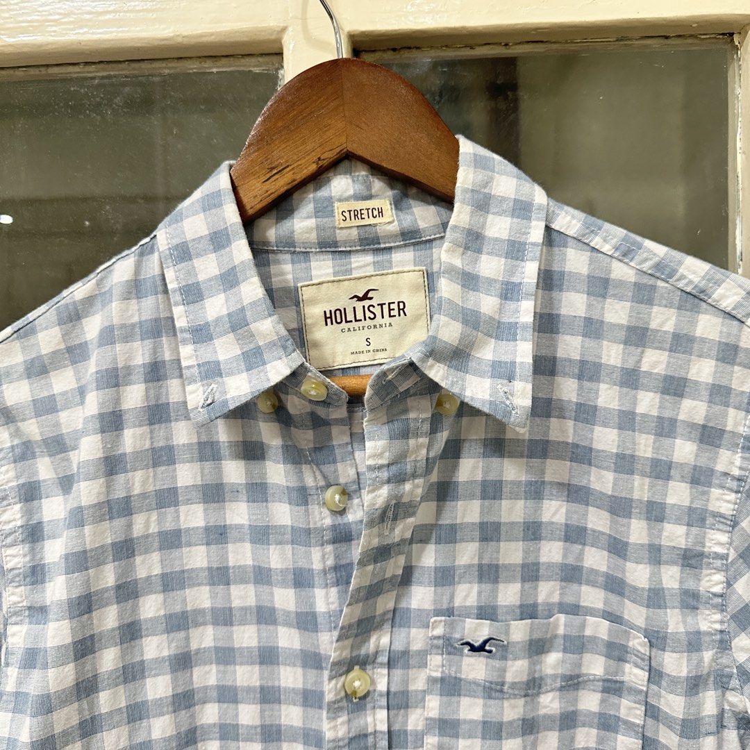 Hollister Blue Gingham Button Down Shirt Size S (Category: Tshirts & Polo Shirts ) located in Makati City. Submitted by _lovejoy (Listing ID 1440289473, Image 2). Description: - Classic blue and white gingham pattern - Long sleeves with button cuffs - Chest pocket with Hollister logo - Comfortable stretch fabric - Button-up front - Ideal for casual wear.