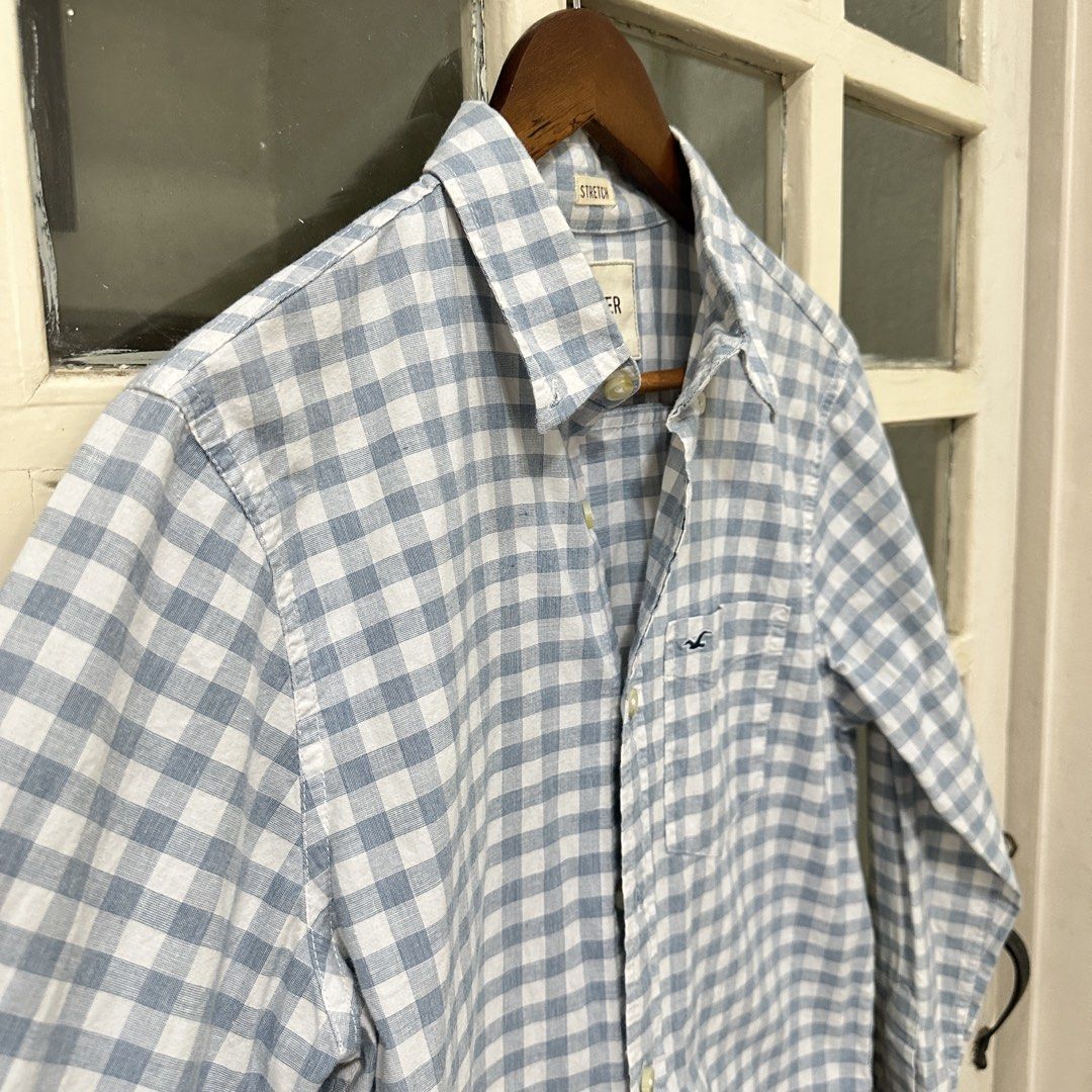 Hollister Blue Gingham Button Down Shirt Size S (Category: Tshirts & Polo Shirts ) located in Makati City. Submitted by _lovejoy (Listing ID 1440289473, Image 3). Description: - Classic blue and white gingham pattern - Long sleeves with button cuffs - Chest pocket with Hollister logo - Comfortable stretch fabric - Button-up front - Ideal for casual wear.