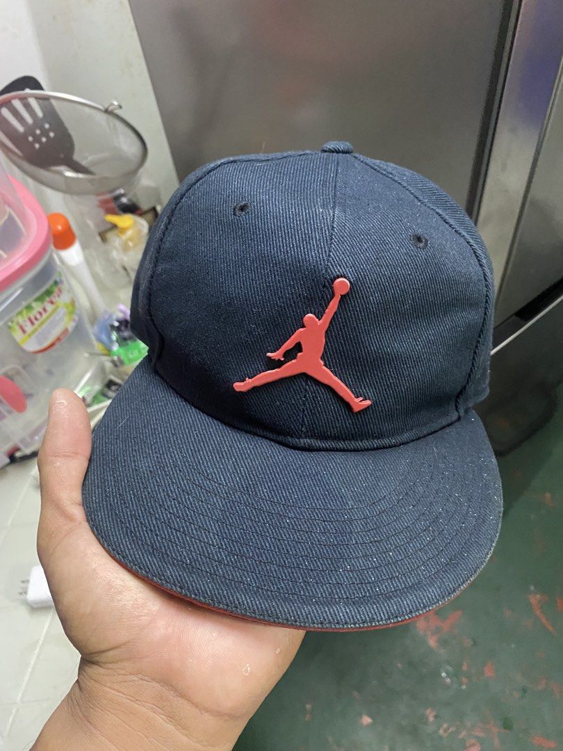 Jordan Cap Red Jumpman Logo Navy Blue (Category: Caps & Hats) located in Manila. Submitted by mindthrift.12 (Listing ID 1440384140, Image 1). Description: - Navy blue Jordan cap - Iconic red Jumpman logo on the front - Smaller red Jumpman embroidered on the side - Tag inside indicates size 7 - Perfect for any Jordan enthusiast.