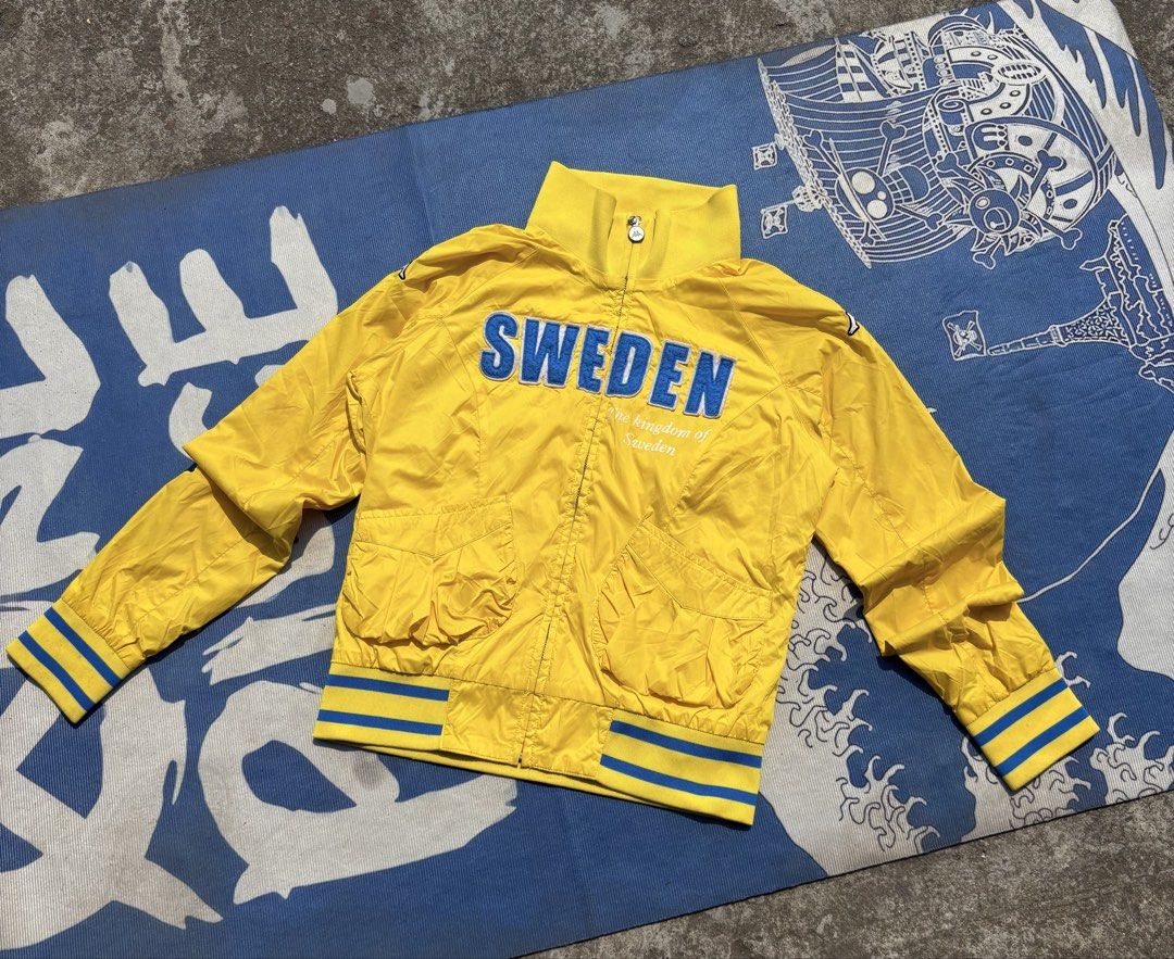 Kappa Sweden Track Jacket Yellow Blue (Category: Coats, Jackets and Outerwear) located in Manila. Submitted by johnrobert.wolf (Listing ID 1440274762, Image 1). Description: - Yellow Kappa track jacket - 'SWEDEN' text across the chest - Blue and yellow striped cuffs and hem - High collar with button closure - Ideal for casual wear or sports -Dimes 22” x 19”.
