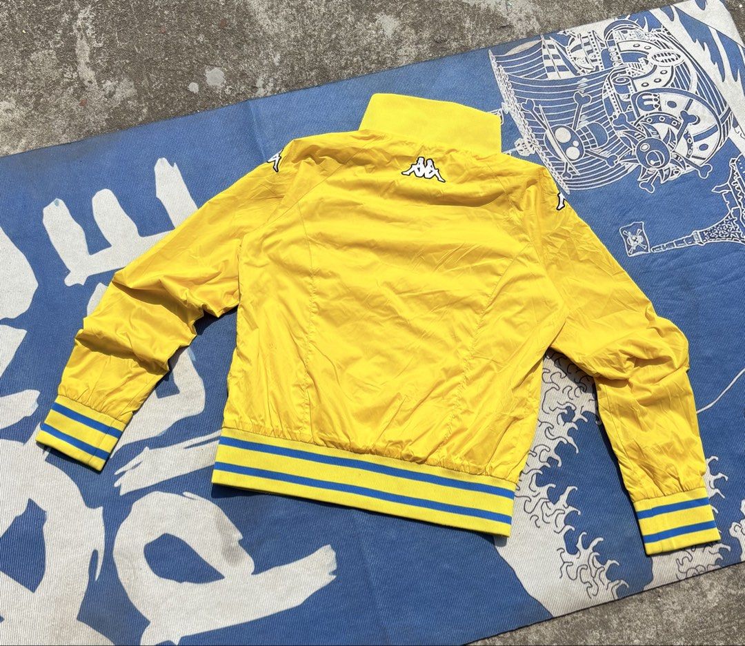 Kappa Sweden Track Jacket Yellow Blue (Category: Coats, Jackets and Outerwear) located in Manila. Submitted by johnrobert.wolf (Listing ID 1440274762, Image 2). Description: - Yellow Kappa track jacket - 'SWEDEN' text across the chest - Blue and yellow striped cuffs and hem - High collar with button closure - Ideal for casual wear or sports -Dimes 22” x 19”.