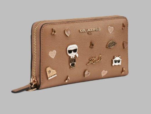 Karl Lagerfeld Zip Around Wallet with Charms (Category: Wallets & Card holders) located in Cavite. Submitted by ahpolm (Listing ID 1440376099, Image 1). Description: - Authentic Karl Lagerfeld zip-around wallet - Adorable charms: Karl Lagerfeld figure, cat, hearts, musical notes - Secure zip-around closure - Ample interior space with numerous card slots and compartments - Detachable wrist strap included - Ideal for keeping your essentials organiz
