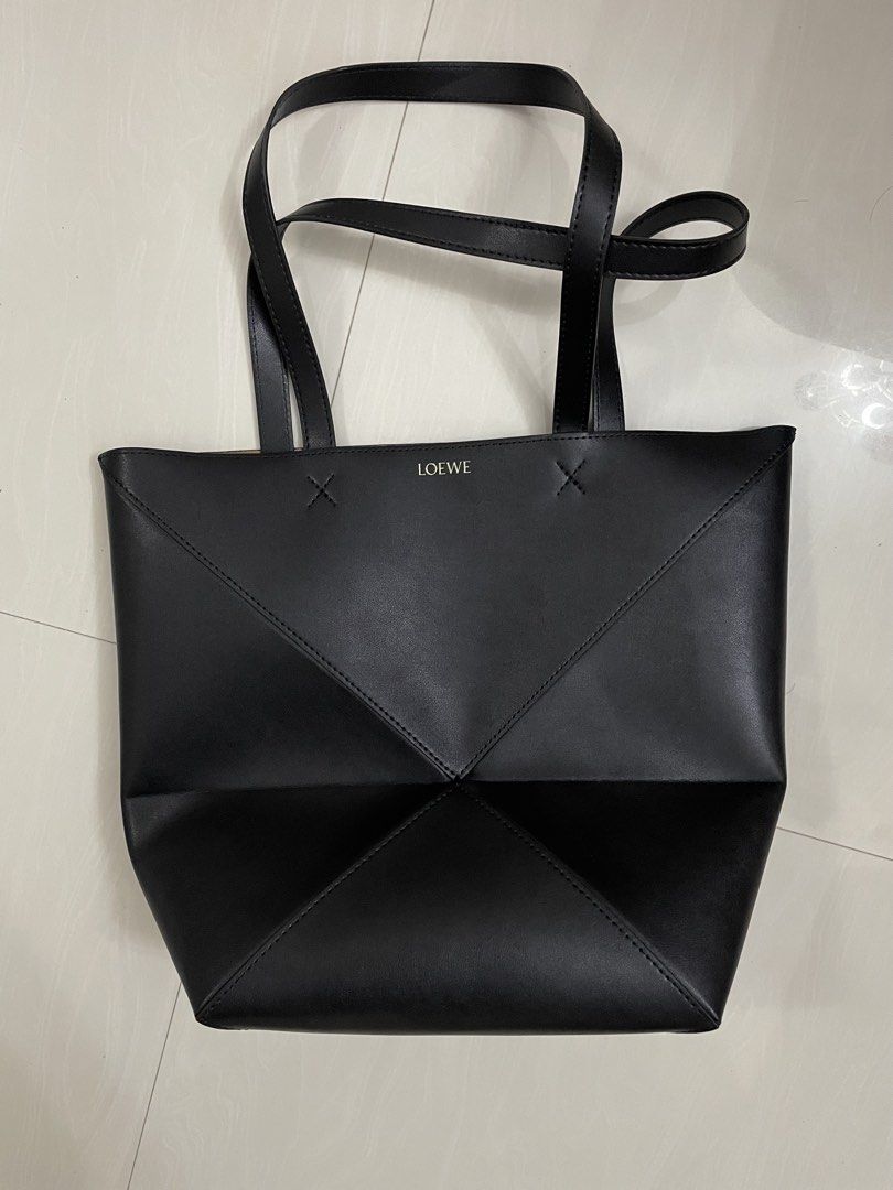 Loewe Origami Tote Bag (Category: Luxury Bags & Wallets) located in Quezon City. Submitted by sheen_calanza (Listing ID 1439504790, Image 2). Description: - Black Loewe Origami tote bag - Unique geometric design - Two top handles - Contrasting brown interior - Made of leather - Loewe logo on the front - Thrifted in japan 🇯🇵.