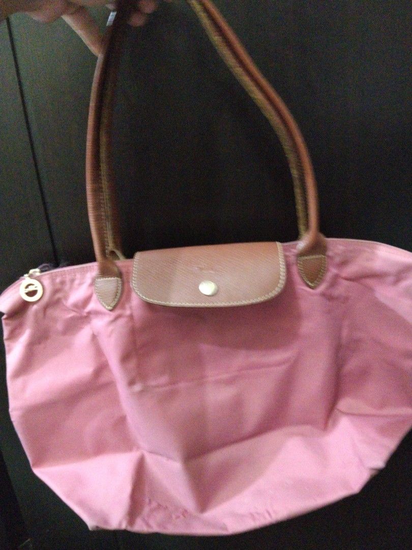 Longchamp Le Pliage Pink Tote Bag (Category: Shoulder Bags) located in Manila. Submitted by rachymae (Listing ID 1440363506, Image 2). Description: - Classic pink Longchamp tote bag - Features elegant leather handles and trim - Folds compactly for easy storage - Ideal for everyday errands or travel - Spacious interior to hold your essentials - Secure closure with zipper and snap button flap all in one listing -minor flaw at the bottom, see pictur
