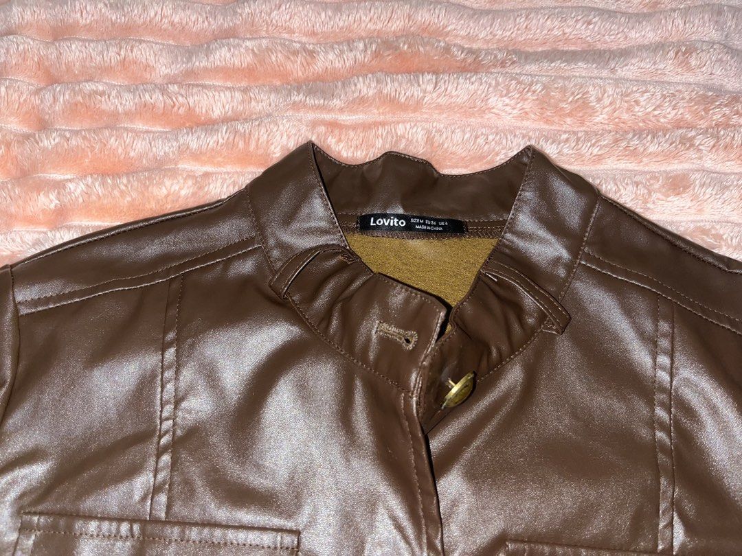 Lovito Brown Faux Leather Cropped Jacket (Category: Coats, Jackets and Outerwear) located in General Trias. Submitted by luckystorm_ (Listing ID 1440345002, Image 2). Description: - Brand: Lovito - Color: Brown - Material: Faux Leather - Style: Cropped Jacket - Collar: Stand-up - Closure: Button-up front - Pockets: Two chest pockets with button closures - Sleeves: Long sleeves with button cuffs and slit detail - Estimated Size: S (based on tag).