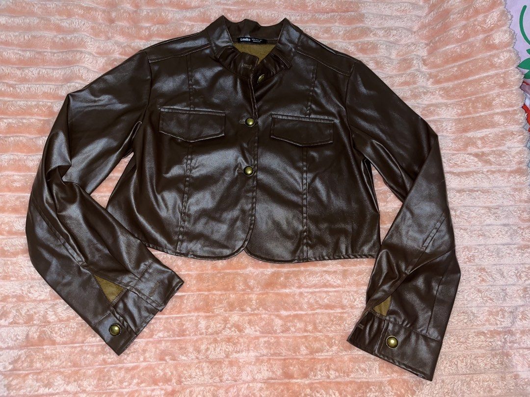 Lovito Brown Faux Leather Cropped Jacket (Category: Coats, Jackets and Outerwear) located in General Trias. Submitted by luckystorm_ (Listing ID 1440345002, Image 1). Description: - Brand: Lovito - Color: Brown - Material: Faux Leather - Style: Cropped Jacket - Collar: Stand-up - Closure: Button-up front - Pockets: Two chest pockets with button closures - Sleeves: Long sleeves with button cuffs and slit detail - Estimated Size: S (based on tag).