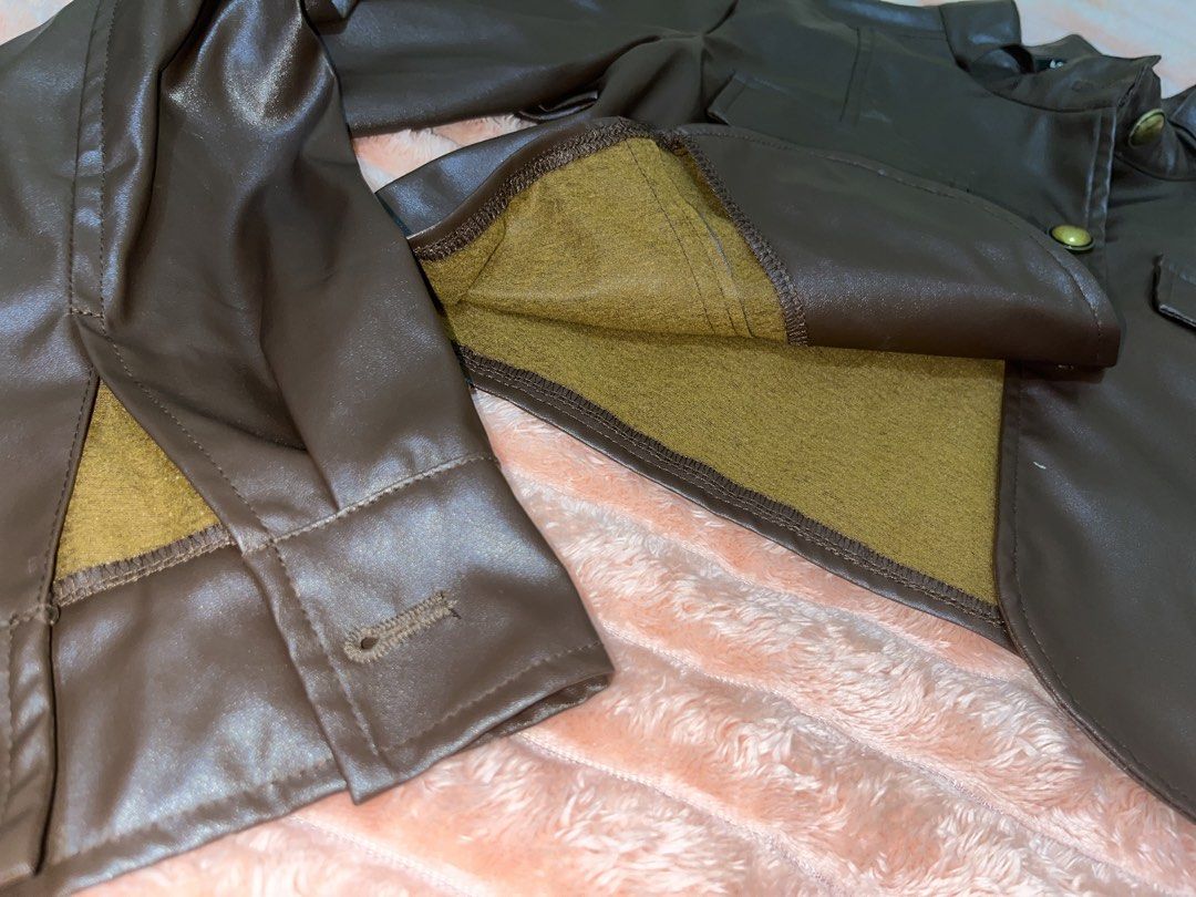 Lovito Brown Faux Leather Cropped Jacket (Category: Coats, Jackets and Outerwear) located in General Trias. Submitted by luckystorm_ (Listing ID 1440345002, Image 3). Description: - Brand: Lovito - Color: Brown - Material: Faux Leather - Style: Cropped Jacket - Collar: Stand-up - Closure: Button-up front - Pockets: Two chest pockets with button closures - Sleeves: Long sleeves with button cuffs and slit detail - Estimated Size: S (based on tag).