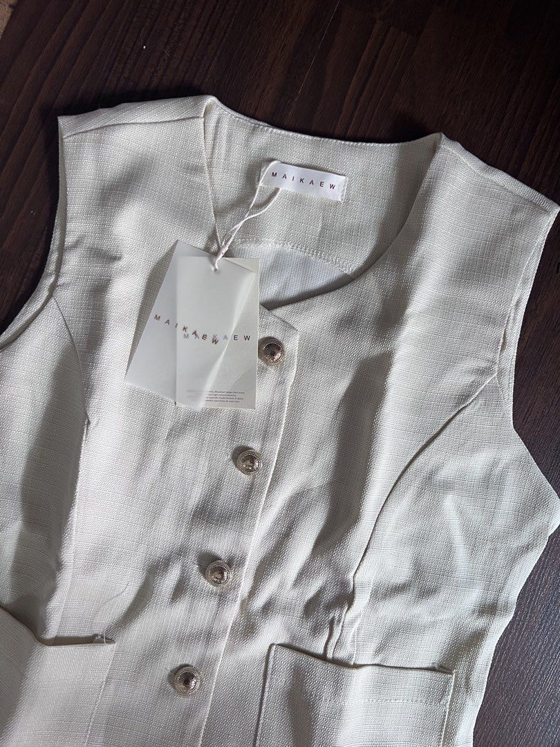 MAIKAEW Beige Sleeveless Button-Up Pleated Co ords (Category: Dresses) located in Antipolo. Submitted by riesns (Listing ID 1440346374, Image 2). Description: - Brand: MAIKAEW (From thailand) - Color: Beige - Style: Sleeveless dress - Features: Button-up front, two front pockets - Skirt: Pleated design - Condition: Brand new with original tags attached - Occasion: Smart casual.