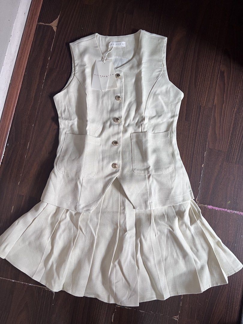 MAIKAEW Beige Sleeveless Button-Up Pleated Co ords (Category: Dresses) located in Antipolo. Submitted by riesns (Listing ID 1440346374, Image 1). Description: - Brand: MAIKAEW (From thailand) - Color: Beige - Style: Sleeveless dress - Features: Button-up front, two front pockets - Skirt: Pleated design - Condition: Brand new with original tags attached - Occasion: Smart casual.