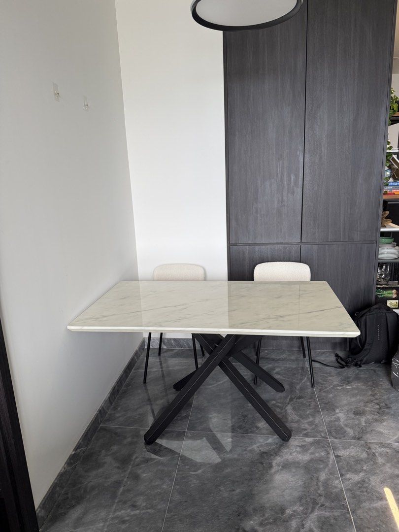 Marble Dining Table (Category: Tables & Sets) located in Singapore. Submitted by markfuszard8148 (Listing ID 1440243817, Image 3). Description: - Rectangular marble top dining table - Black metal criss-cross legs - 140cm x 80cm - Modern design - Great condition - Sits 6 comfortably - Cost over $1k new.