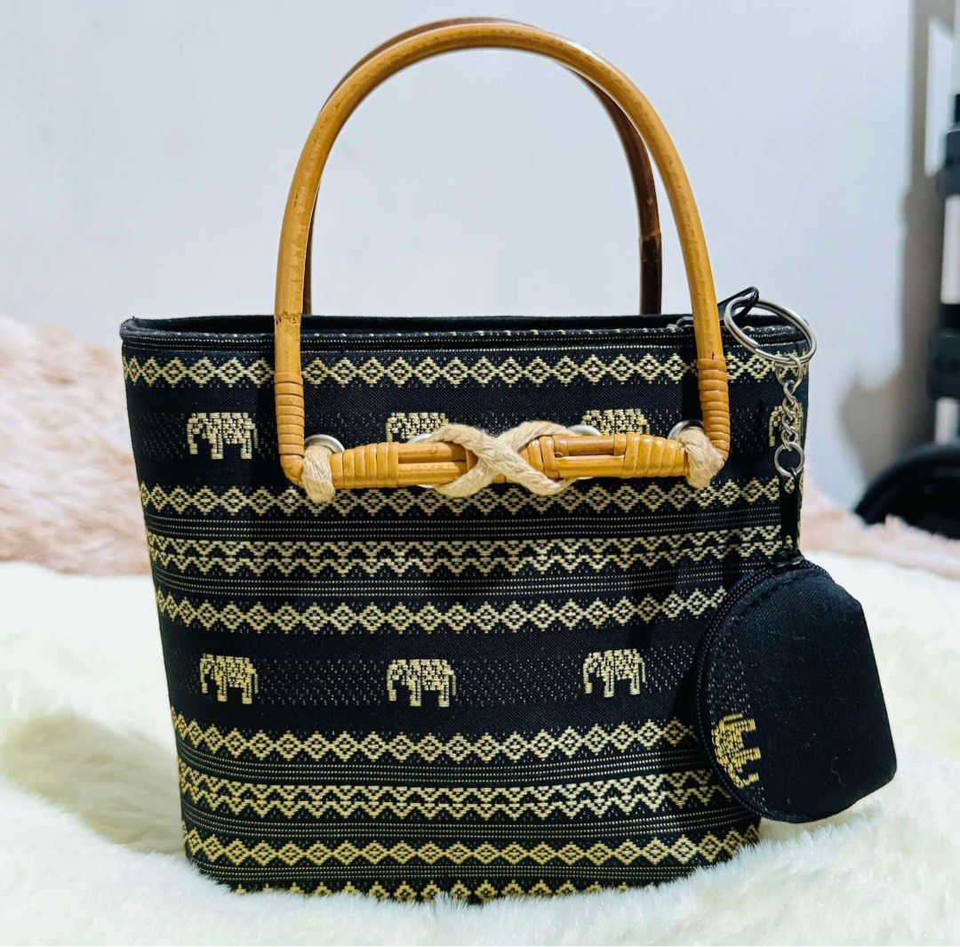 Mini Black Elephant Pattern Bamboo Handle and Handbag with Coin Pouch (Category: Luxury Bags & Wallets) located in Mandaue City. Submitted by chuchi152615 (Listing ID 1440344288, Image 1). Description: - Cute black handbag - Gold elephant and geometric patterns - Bamboo handles - Rope detail - Matching coin pouch attached - Zipper closure - Ideal for casual outings - Approximate dimensions: 6 inches tall x 5 inches wide.