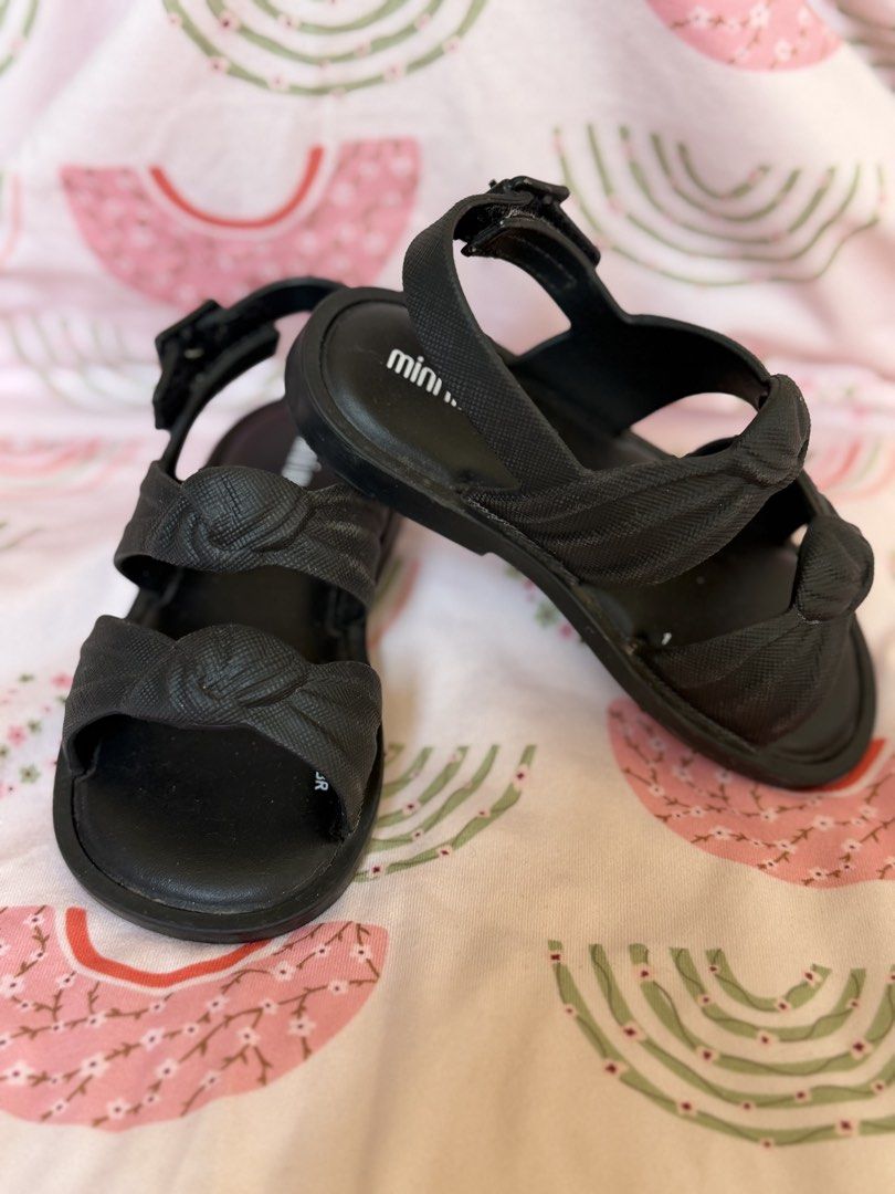 Mini Melissa Isabela Capeto Sandals - Black & Lavender (Category: Babies & Kids Fashion) located in Baguio. Submitted by alexlyone (Listing ID 1440199223, Image 3). Description: Size: US 7 Seldom used Bundle price - Adorable Mini Melissa sandals for your little one. - Available in classic black with a stylish knotted strap. - Charming lavender pair with intricate floral cut-outs. - Comfortable design for all-day wear. - Easy velcro closures for a