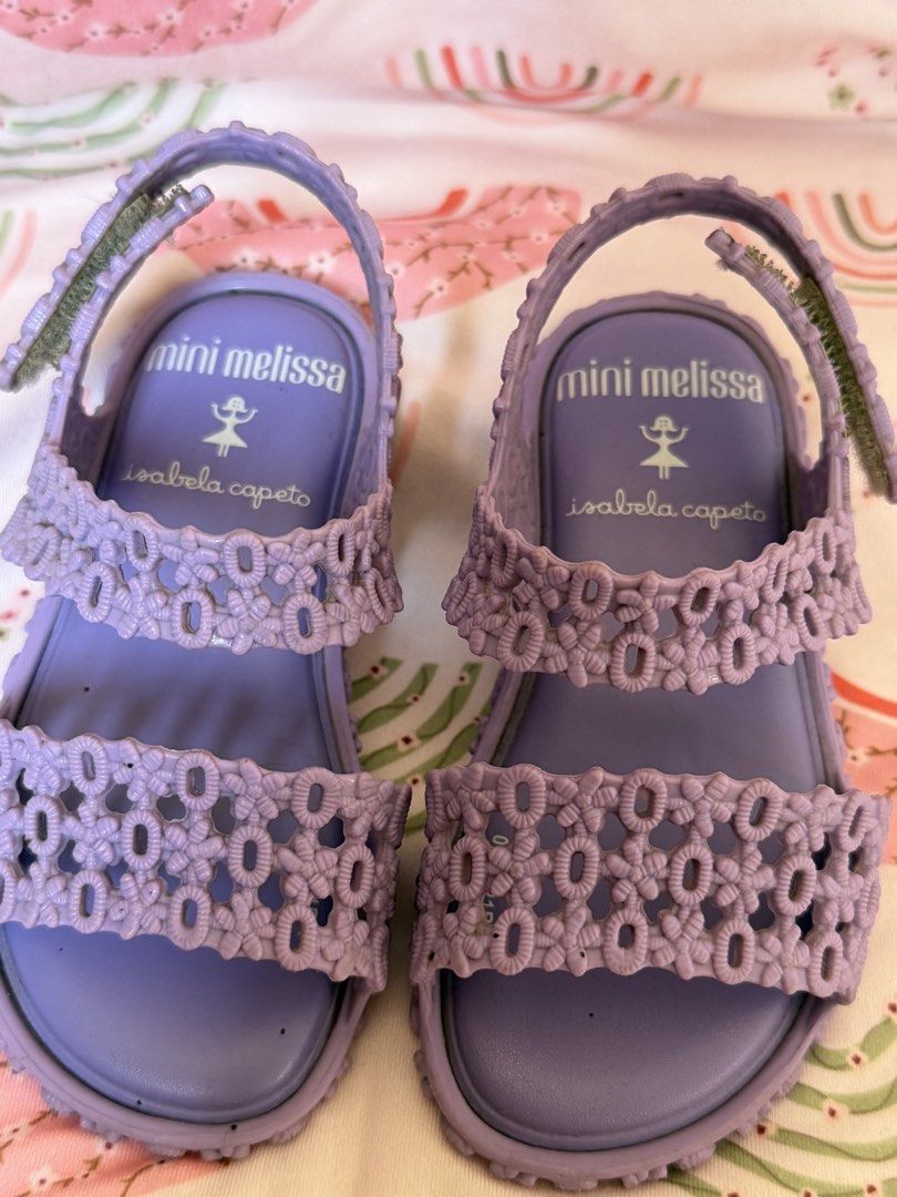 Mini Melissa Isabela Capeto Sandals - Black & Lavender (Category: Babies & Kids Fashion) located in Baguio. Submitted by alexlyone (Listing ID 1440199223, Image 2). Description: Size: US 7 Seldom used Bundle price - Adorable Mini Melissa sandals for your little one. - Available in classic black with a stylish knotted strap. - Charming lavender pair with intricate floral cut-outs. - Comfortable design for all-day wear. - Easy velcro closures for a