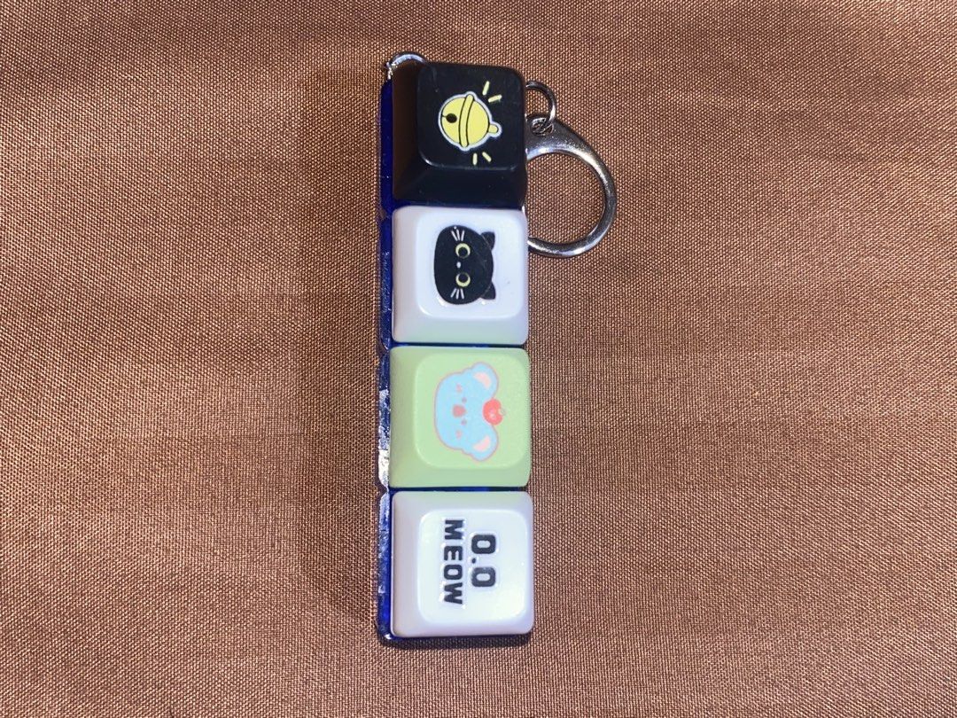 MR DIY Malaysia Fidget Toy (Category: Character Goods) located in Manila. Submitted by dianaclutz (Listing ID 1440237543, Image 3). Description: - MR DIY Malaysia Fidget Toy Keychain - Features stacked cubes with fun designs (bell, cat, character, 'meow') - Ideal for sensory play and stress relief - Attaches easily to bags or keys -Good as new.