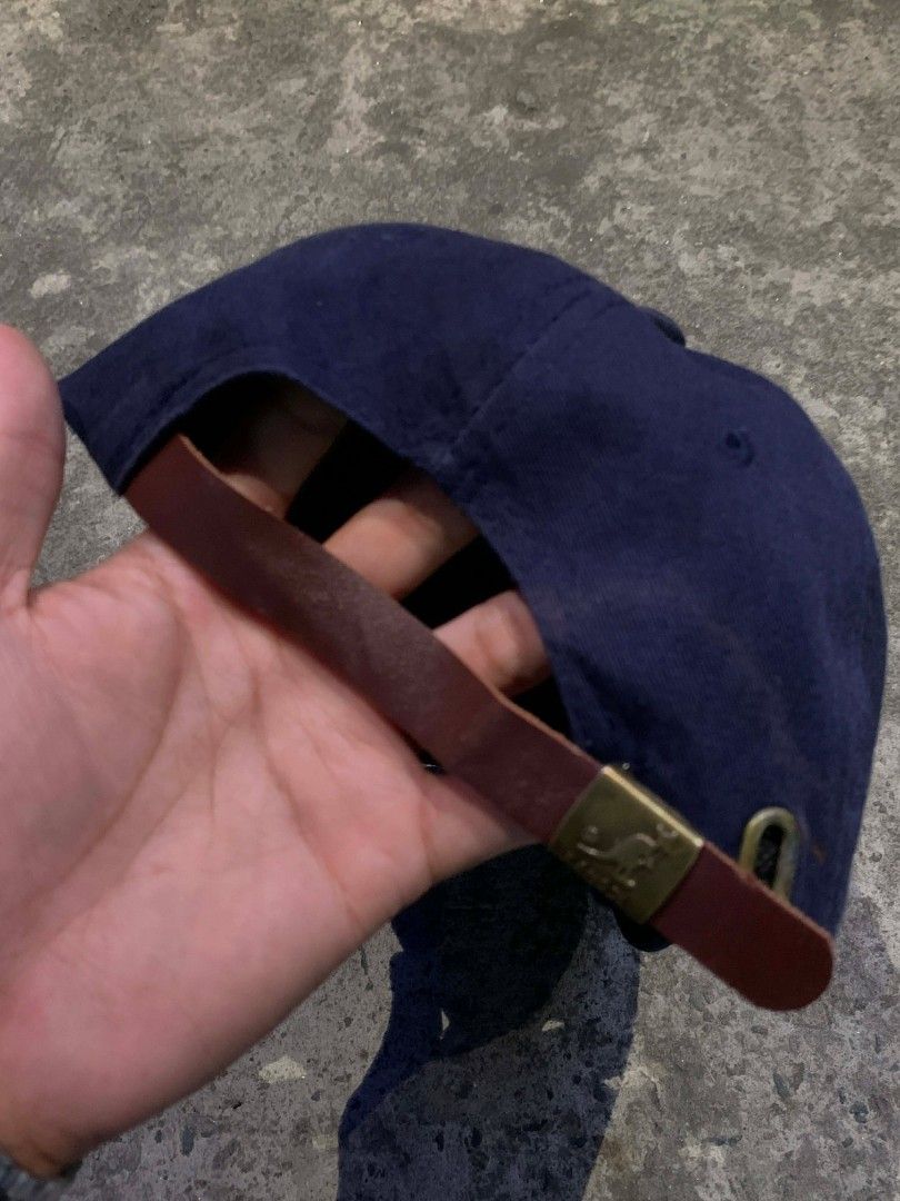 Navy Kangol Cap with Yellow Kangaroo Logo (Category: Caps & Hats) located in Manila. Submitted by thrift2mnla (Listing ID 1440350364, Image 3). Description: - Classic navy blue Kangol cap - Iconic yellow kangaroo logo embroidered on front - Adjustable leather strap with metal buckle.