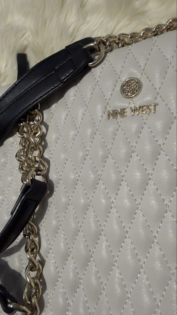 Nine West Quilted Tote Bag with Chain Strap (Category: Shoulder Bags) located in Rizal. Submitted by cutiefindspreloveditems (Listing ID 1440369346, Image 3). Description: - Brand: Nine West - Color: White and Black - Style: Quilted Tote Bag - Features: Gold chain strap, multiple interior compartments - Includes: Original dust bag, paper bag and receipt - Versatile: Great for everyday use or a night out.