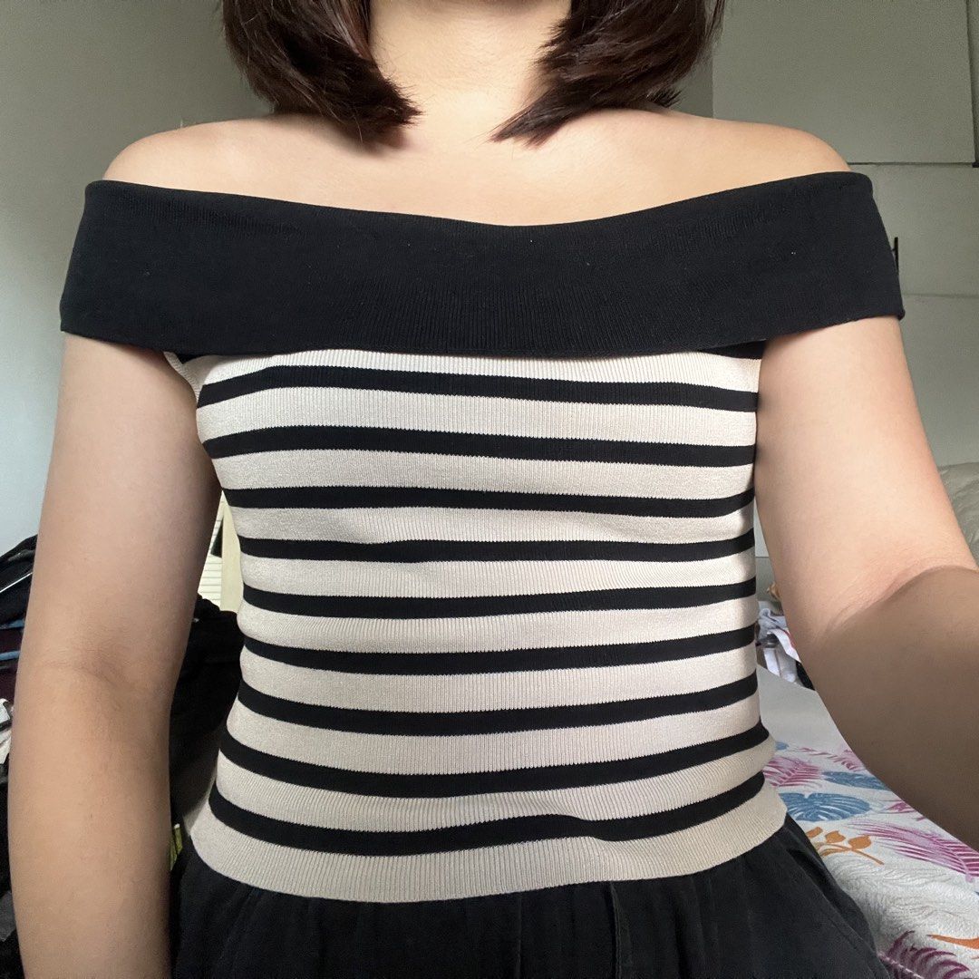 Off-Shoulder Striped Knit Top (Category: Blouses) located in San Juan City. Submitted by 1104basics (Listing ID 1440317536, Image 2). Description: - Black and cream striped knit top - Stylish off-shoulder design - Stretchy and comfortable material - Flattering fit for any occasion - Versatile for casual outings or dressing up Freesize Model is size small to med for reference .