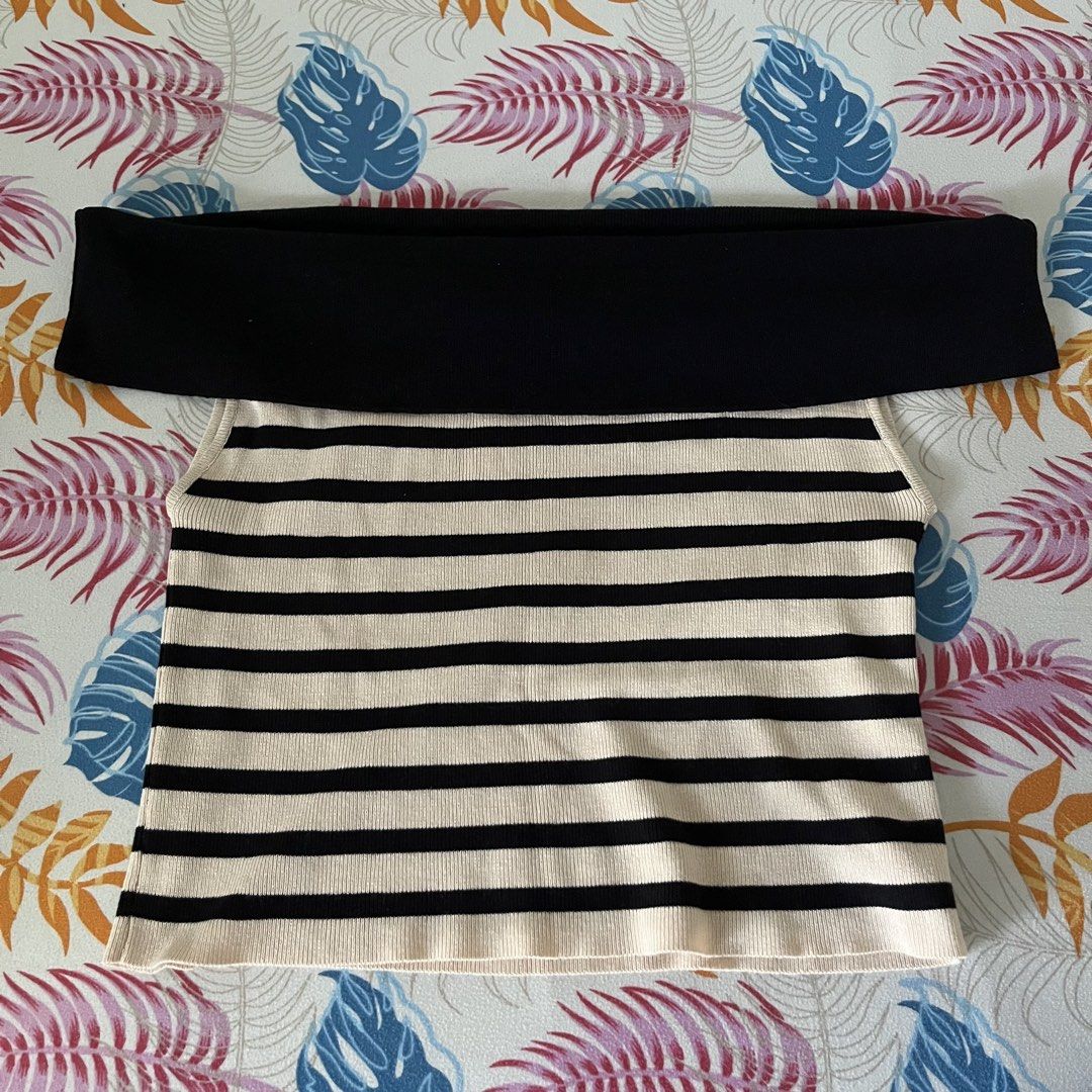 Off-Shoulder Striped Knit Top (Category: Blouses) located in San Juan City. Submitted by 1104basics (Listing ID 1440317536, Image 1). Description: - Black and cream striped knit top - Stylish off-shoulder design - Stretchy and comfortable material - Flattering fit for any occasion - Versatile for casual outings or dressing up Freesize Model is size small to med for reference .