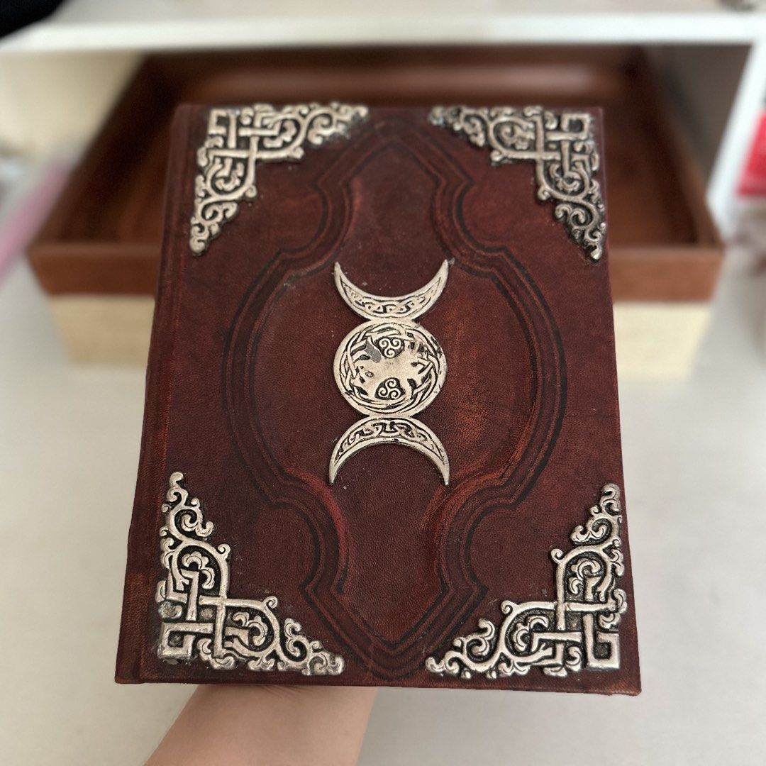 OLD Triple Goddess Embossed Leather Journal - Old World Style Notebook (Category: Storybooks) located in Mexico. Submitted by amidalajewelryandartifacts (Listing ID 1440261932, Image 1). Description: Product Description: Old Handcrafted Leather Journal / Notebook with Triple Goddess Emblem Beautifully crafted, old-world style leather journal featuring a striking central metal emblem of the Triple Goddess (Triple Moon) with intricate Celtic knotwo