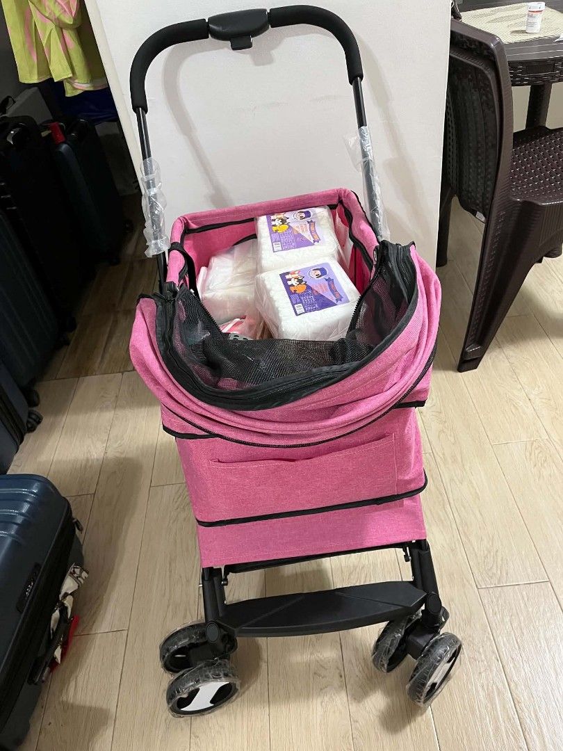 Pink Pet Stroller for Small Dogs or Cats (Category: Homes & Other Pet Accessories) located in Pasig City. Submitted by rrabeto13 (Listing ID 1440251871, Image 2). Description: - Pink pet stroller - Features a canopy and mesh windows for ventilation - Includes a convenient storage basket underneath - Swivel wheels for smooth and easy maneuvering - Folds down for compact storage - Ideal for taking your furry friend on adventures.