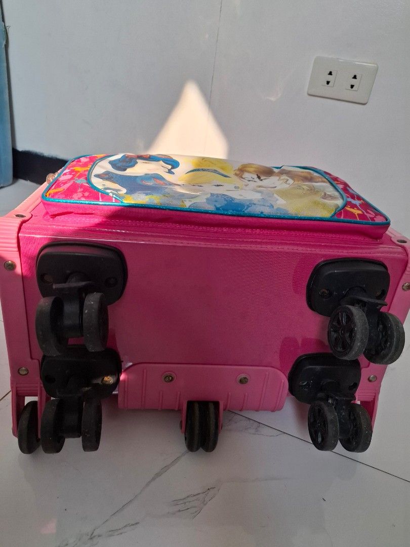 Pink Princess Rolling Luggage Set with Matching Bag (Category: Other Babies Going Out Needs) located in Naic. Submitted by ramatrendph (Listing ID 1440212368, Image 3). Description: - Adorable pink rolling luggage set for kids. - Features beloved Disney Princesses on the front. - Comes with a smaller matching bag that attaches securely to the front. - Equipped with a retractable handle for easy carrying. - Smooth-rolling wheels for effortless tra