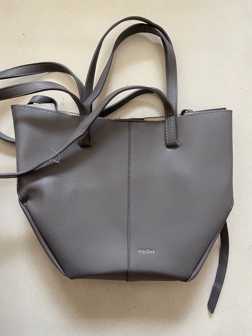 Polène Grey Textured Leather Tote Bag with Pouch (Category: Tote Bags) located in Quezon City. Submitted by kingcurator (Listing ID 1440272273, Image 1). Description: - Grey Polène tote bag - Textured leather - Includes matching inner pouch - Features top handles - Detachable shoulder strap included - Secure magnetic snap closure - Crafted in Spain - Ideal for daily use - Compressed in luggage not yet used - Bag included only with small pouch ins