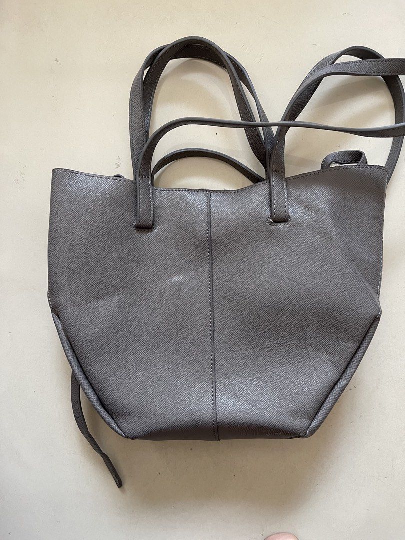 Polène Grey Textured Leather Tote Bag with Pouch (Category: Tote Bags) located in Quezon City. Submitted by kingcurator (Listing ID 1440272273, Image 2). Description: - Grey Polène tote bag - Textured leather - Includes matching inner pouch - Features top handles - Detachable shoulder strap included - Secure magnetic snap closure - Crafted in Spain - Ideal for daily use - Compressed in luggage not yet used - Bag included only with small pouch ins