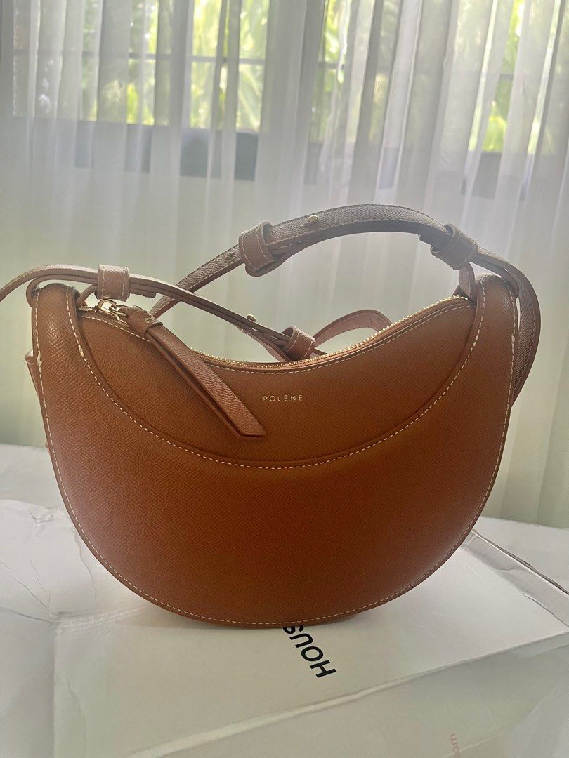 Polène "Numero Dix" Bag in Tan Leather (Category: Shoulder Bags) located in Mandaluyong City. Submitted by marycris89 (Listing ID 1440241216, Image 1). Description: Polene Numero Dix in Tan Leather - No box/Dust bag - In very good condition - Elegant crescent-shaped handbag by Polène. - Crafted from textured tan leather. - Features contrasting white stitching. - Secure zip closure. - Adjustable shoulder strap for versatile styling. - Interior sli