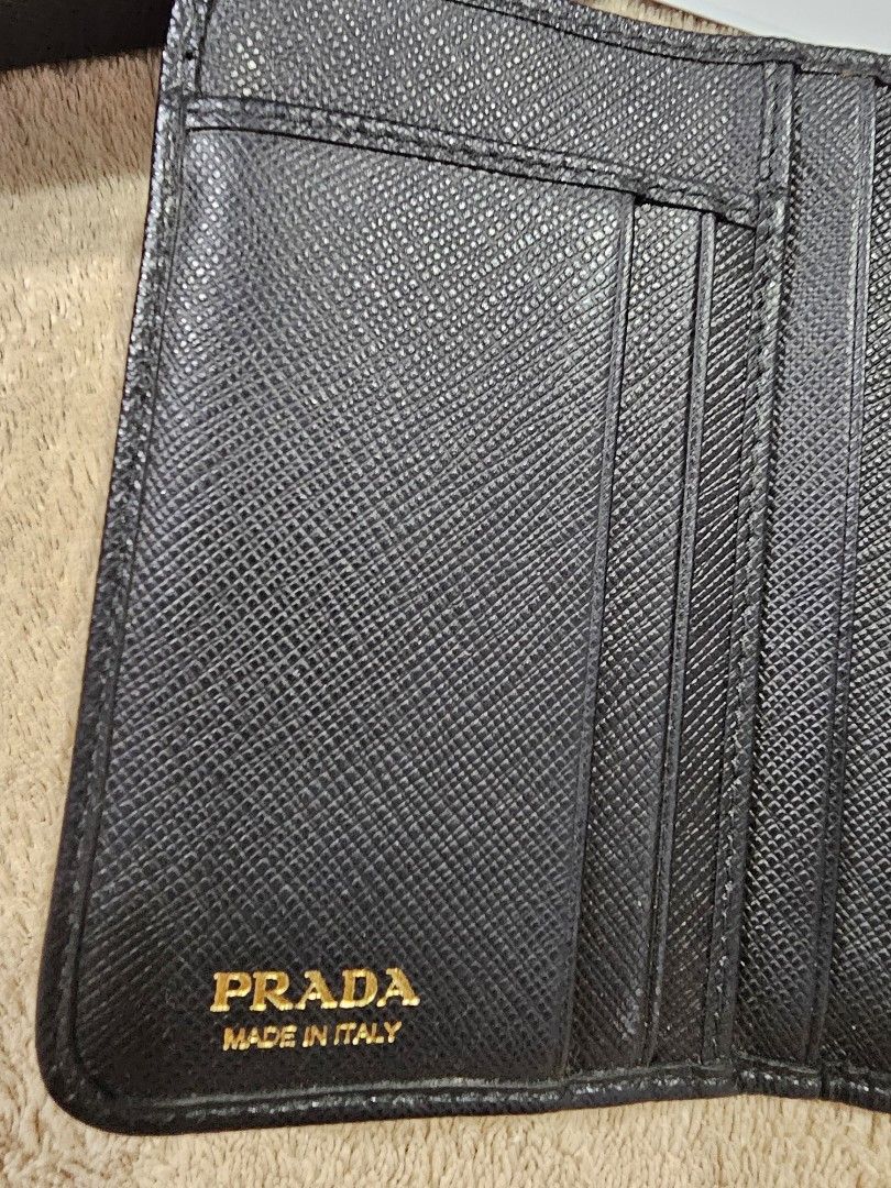 Prada Nero Tessuto Bi-fold Wallet (Category: Luxury Bags & Wallets) located in Mandaluyong City. Submitted by mlstuff28 (Listing ID 1440319356, Image 3). Description: - Authentic Prada Wallet - Material: Black Tessuto - Design: Bi-fold with Snap Closure - Interior: Multiple Card Slots & Compartments - Includes: Original Box & Authenticity Card Issue: snap buttton Mop: bank transfer.