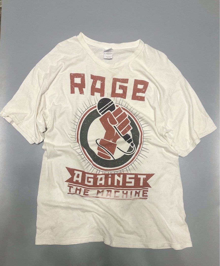 Rage Against The Machine T-Shirt Size L (Category: Tshirts & Polo Shirts ) located in Alaminos. Submitted by outfitcheck.ph (Listing ID 1440284730, Image 1). Description: - Iconic Rage Against The Machine white t-shirt - Features the classic logo with a fist holding a microphone graphic - Made from comfortable 100% cotton by Gildan - Size: Large - A must-have for any fan of the band!.