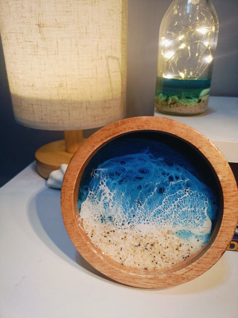 Resin Ocean Wave WoodenCoaster (Category: Other Home Decor) located in Calumpit. Submitted by ells25 (Listing ID 1440293892, Image 2). Description: - Beautiful handmade resin coaster - Realistic ocean wave design with sandy beach and clear blue water - Natural wooden rim - Protects surfaces from drinks - Can also be used as a trinket dish for keys or jewelry - Unique piece for home decor.