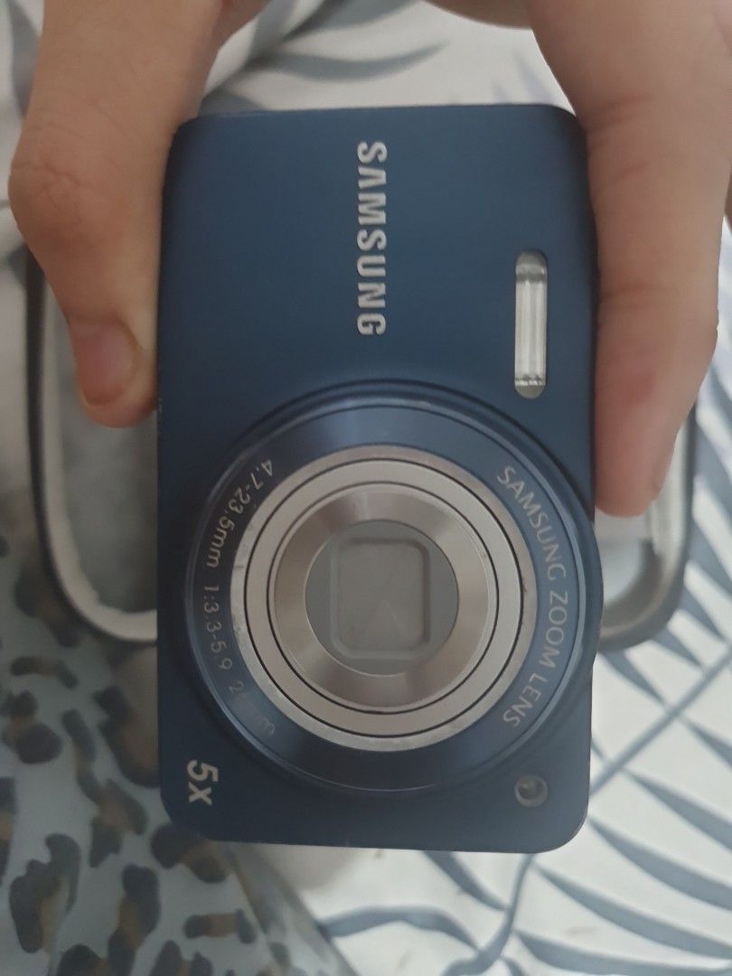 Samsung Digital Camera with 5x Optical Zoom (Category: Cameras) located in Manila. Submitted by s3nse (Listing ID 1440288027, Image 1). Description: - Blue Samsung digital camera - 5x optical zoom lens - Back features screen and navigation buttons - Comes with protective case - Includes beaded strap - Ideal for casual photography.