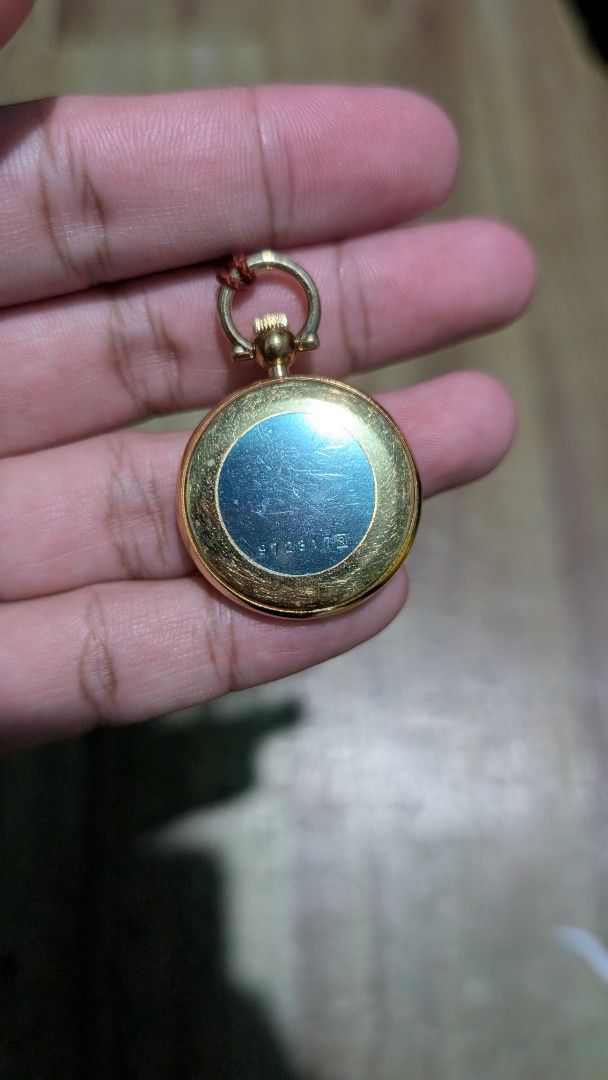 Seiko Quartz Pocket Watch with Tassel (Category: Men's Watches) located in Manila. Submitted by kingractis62231 (Listing ID 1440377185, Image 2). Description: - Gold-tone Seiko pocket watch - White dial with black Arabic numerals - Reliable quartz movement - Comes with a red braided cord and tassel - Working condition - Ideal for collectors or as a unique fashion statement.
