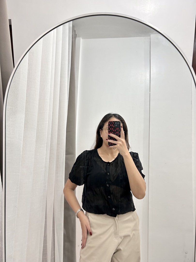 Sheer Black Puff Sleeve Button-Up Blouse (Category: Blouses) located in Caloocan City. Submitted by avryph (Listing ID 1440360069, Image 1). Description: - Cute sheer black blouse - Features puff sleeves - Button-up front - Textured fabric - Versatile for dressing up or down - Pairs well with high-waisted pants or skirts.