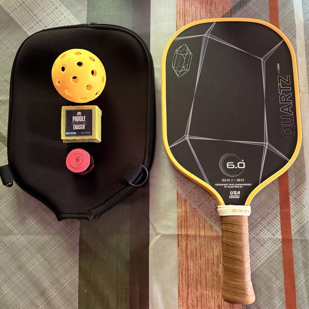 SIX ZERO QUARTZ 6.0 Pickleball Paddle with Accessories (Category: Racket and Ball Sports) located in Muntinlupa City. Submitted by mjccld (Listing ID 1440245308, Image 1). Description: Bought it for 6, 495 (JUEGO) Selling for 4,500 only!! All in with accessories na po -Paddle includes: 1 paddle cover, 1 training ball, 1 paddle grip, 1 paddle eraser - Lady owner - 15 mm thicknes, perfect for begginers - Like new! No any scratches (edge guard prote