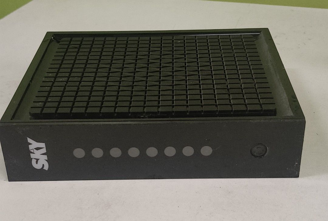 SKY Internet Modem Router (Category: Networking) located in Manila. Submitted by luizzi (Listing ID 1440247465, Image 2). Description: - Black SKY internet modem router - Prominent SKY logo on front and top - Front panel with indicator lights and power button - Textured grid pattern on top - Ideal for home internet connectivity.